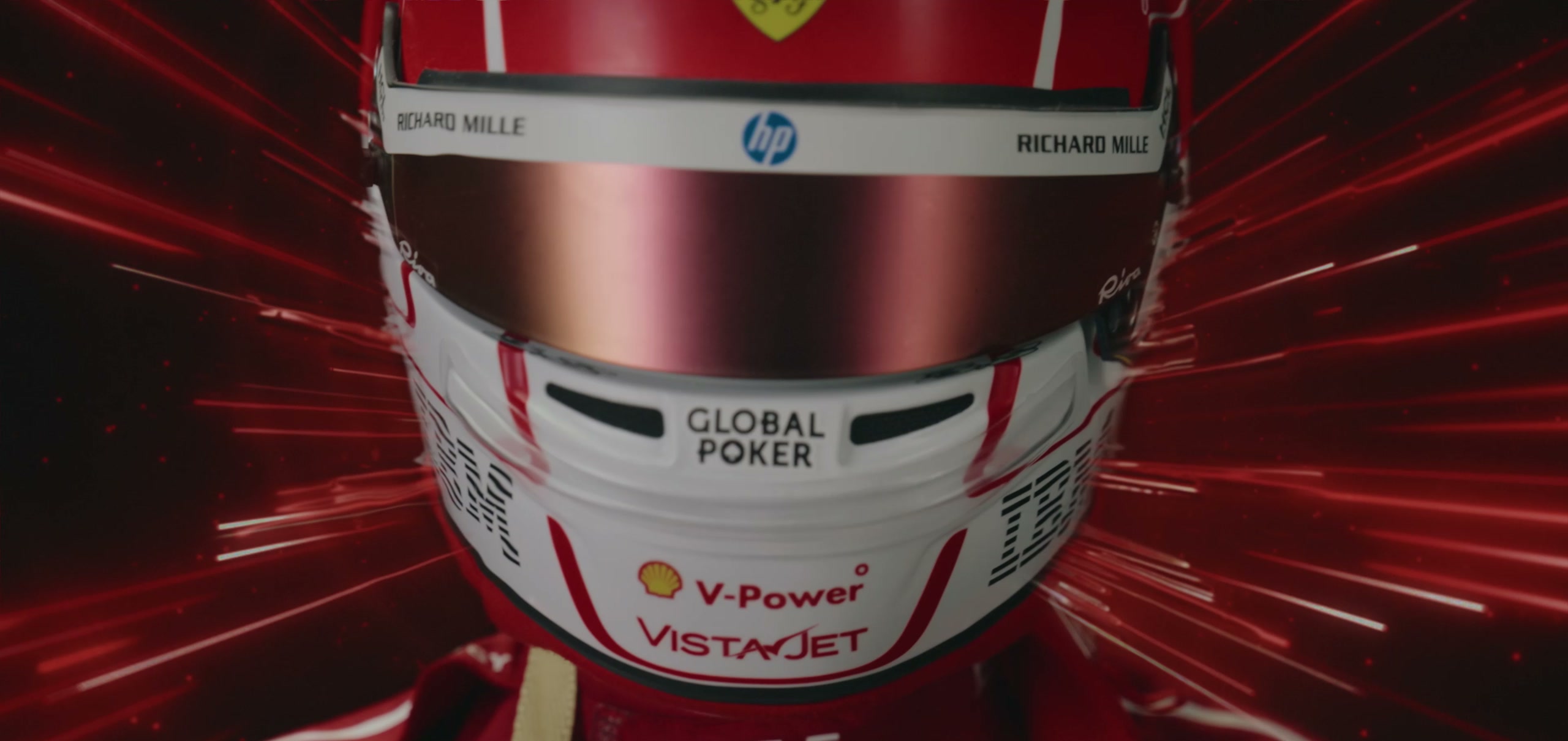 Charles Leclerc's Ferrari helmet lit by streaking red light