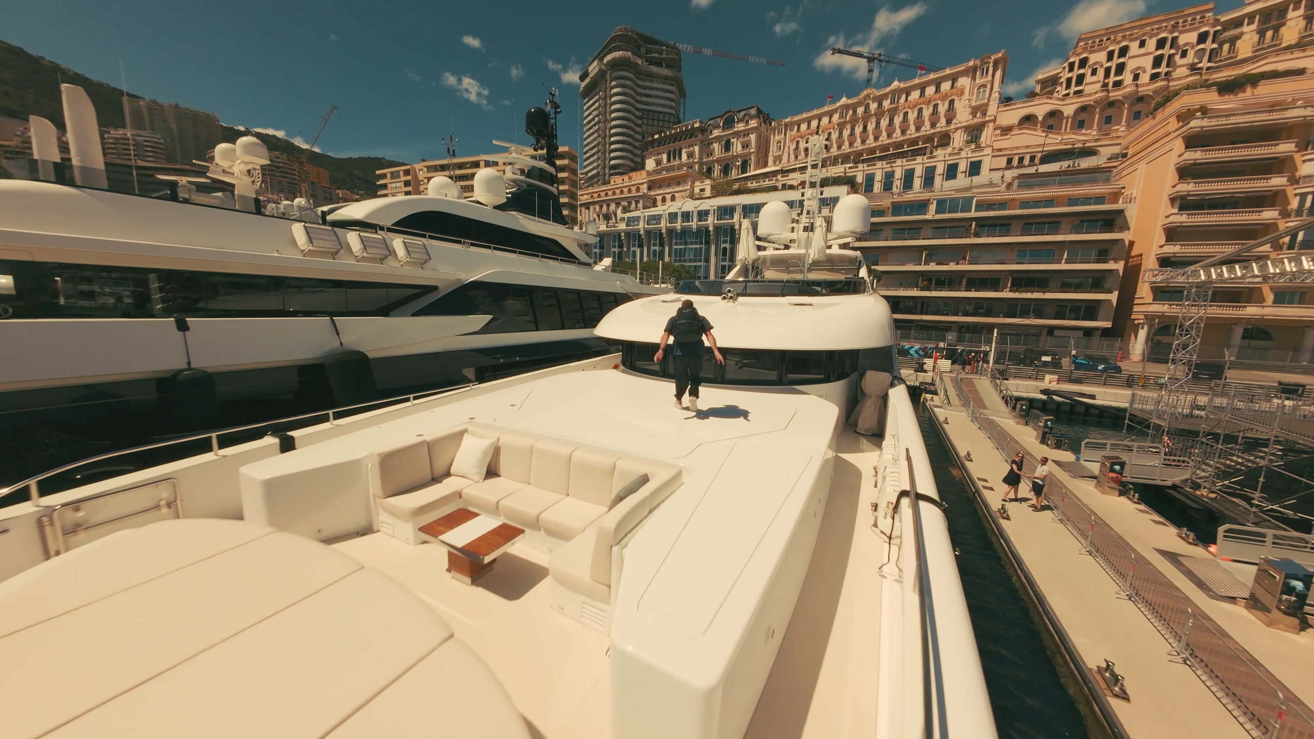 Parkour athlete running across a yacht in Monaco harbour